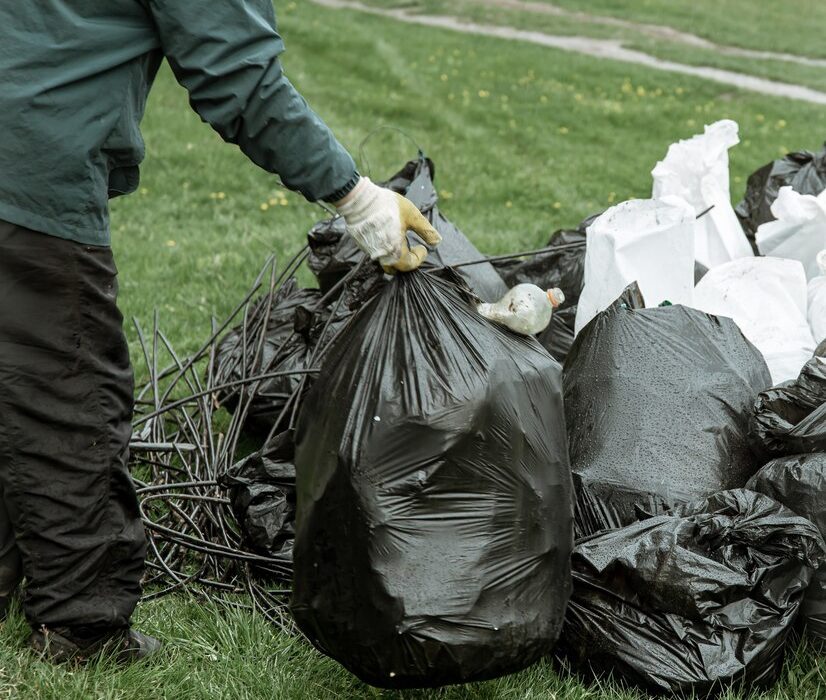 Bin bags filled with mixed waste, including non-recyclable items such as plastic bags, food packaging, and other contaminants, which disrupt proper recycling processes