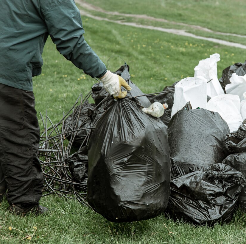 Bin bags filled with mixed waste, including non-recyclable items such as plastic bags, food packaging, and other contaminants, which disrupt proper recycling processes